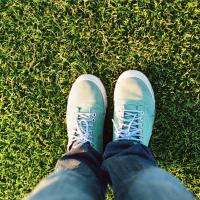 someone standing on green grass